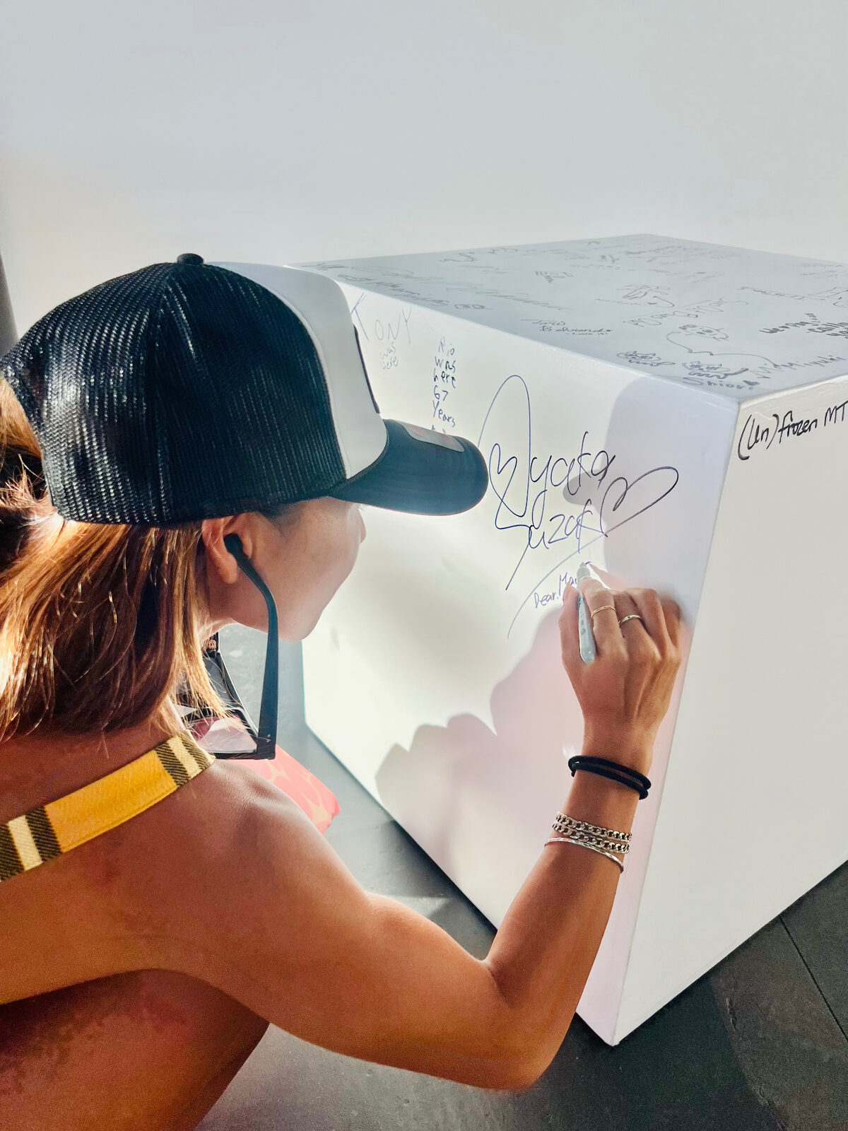 A customer signing her name on the Maui Frozen table in the Kīhei shop